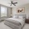 bedroom with a large window and night stands on each side of a bed