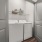closet with a washer and dryer and shelf above